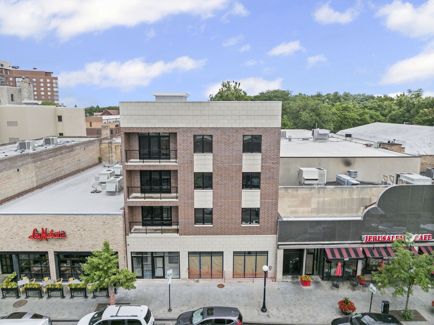 1036 Lake Street, Unit 3N Oak Park, IL 60301 - Photo 1 of 24 a front view of a building with glass windows and plants