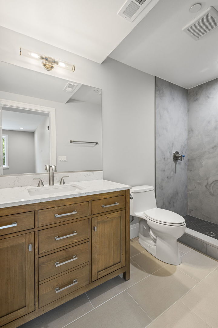 1036 Lake Street, Unit 3N Oak Park, IL 60301 - Photo 17 of 24 a bathroom with a granite countertop toilet sink and mirror