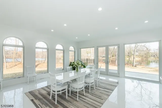 a view of a dining room with furniture large windows and wooden floor