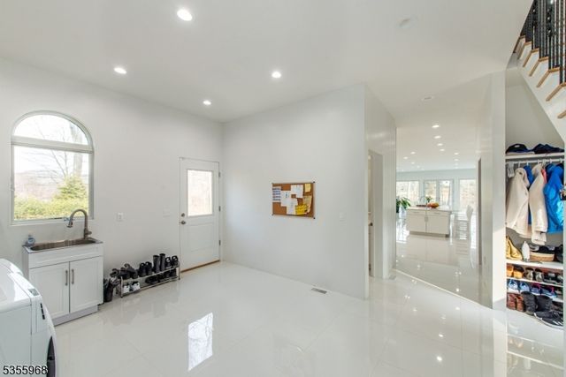 a view of entryway with stairs and wooden floor