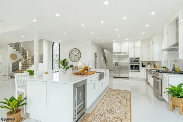 a kitchen with stainless steel appliances kitchen island granite countertop a stove and a sink