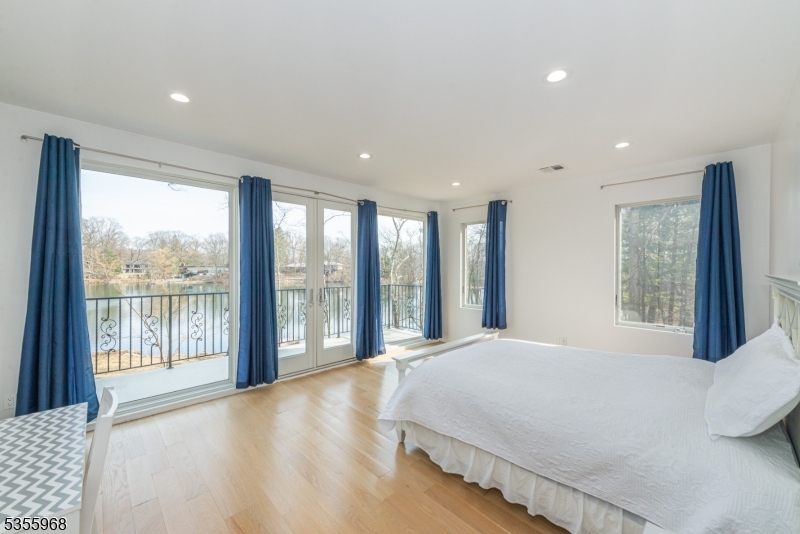 34 West Shore Road Mountain Lakes, NJ 07046 - Photo 15 of 43 a large bedroom with a large bed and a large window