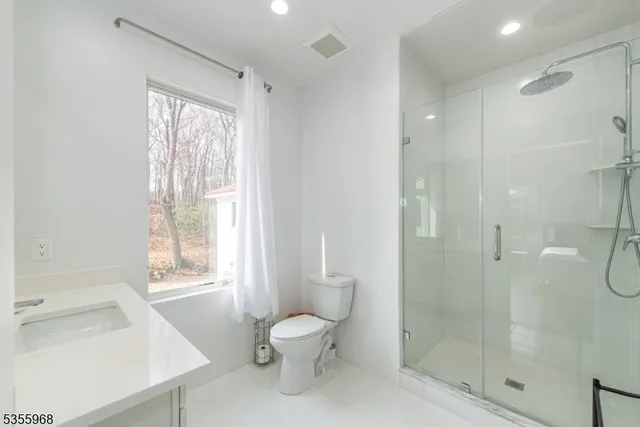 a spacious bedroom with a large bed and a flat screen tv