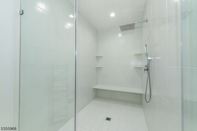 a white bath tub sitting next to a white sink