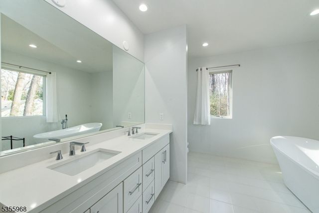 a spacious bedroom with a bed and a large window