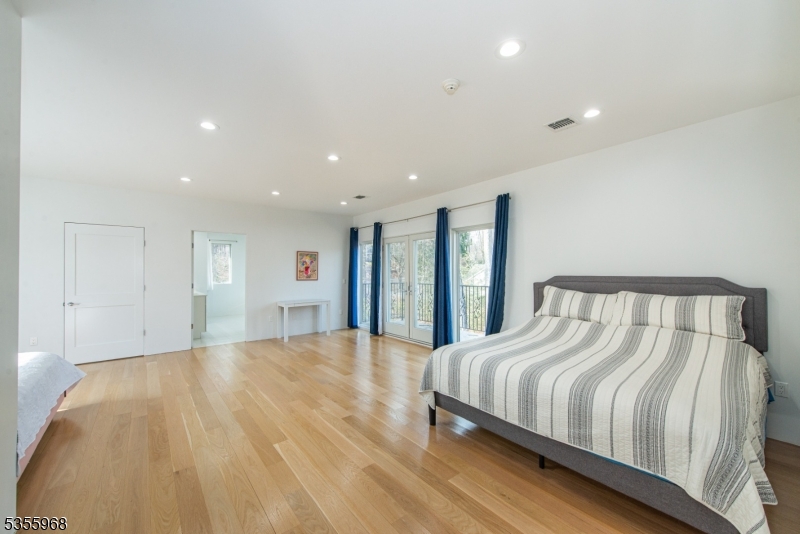 34 West Shore Road Mountain Lakes, NJ 07046 - Photo 27 of 43 a spacious bedroom with a bed and a large window