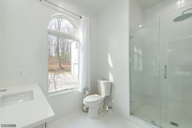 a spacious bedroom with a bed and a large window