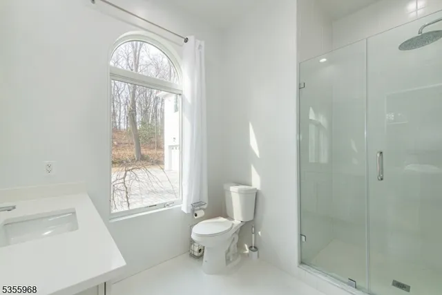 a spacious bedroom with a bed and a large window