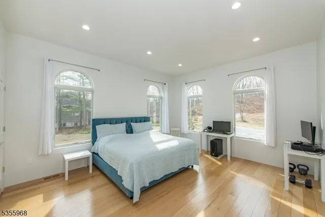 a spacious bedroom with a bed and a large window