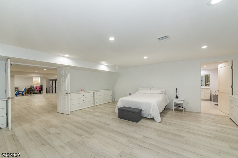 34 West Shore Road Mountain Lakes, NJ 07046 - Photo 35 of 50 a spacious bedroom with a bed and a large window