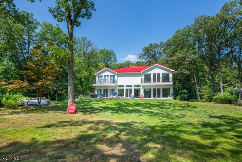 34 West Shore Road Mountain Lakes, NJ 07046 - Photo 36 of 43 a view of a house next to a big yard and large trees