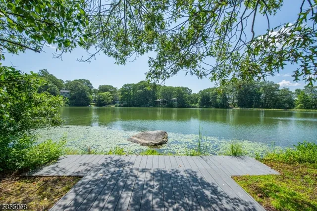 a view of a lake with a table and a chairs