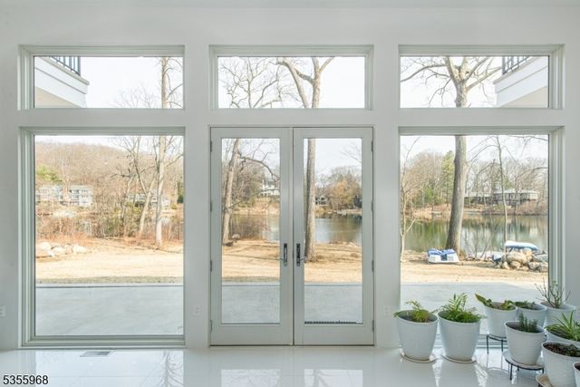 a view of an empty room and floor to ceiling windows