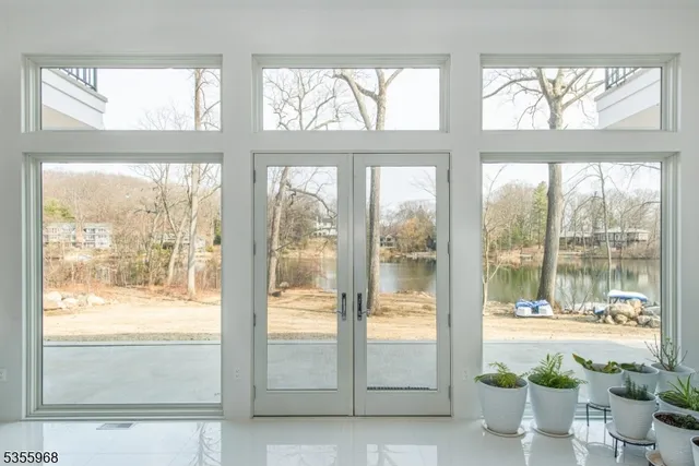 a view of an empty room and floor to ceiling windows