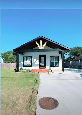 a front view of a house with outdoor seating