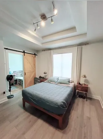a bedroom with a bed and large mirror