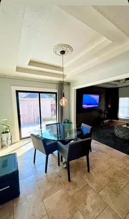 a living room with furniture a table and a flat screen tv