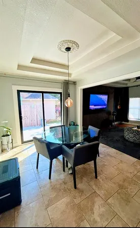 a living room with furniture a piano and a fireplace
