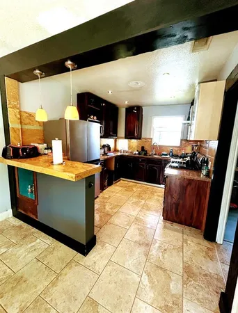 a kitchen with stainless steel appliances kitchen island granite countertop a sink and cabinets