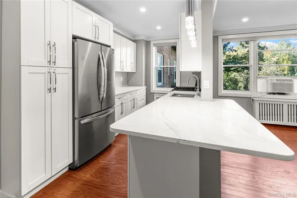 a kitchen with stainless steel appliances a refrigerator and a stove top oven