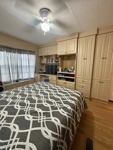 a bedroom with a bed and a chandelier