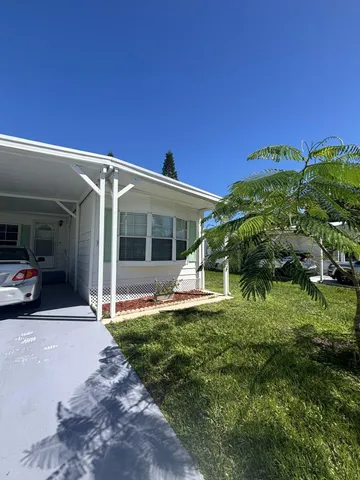a view of a house with a backyard