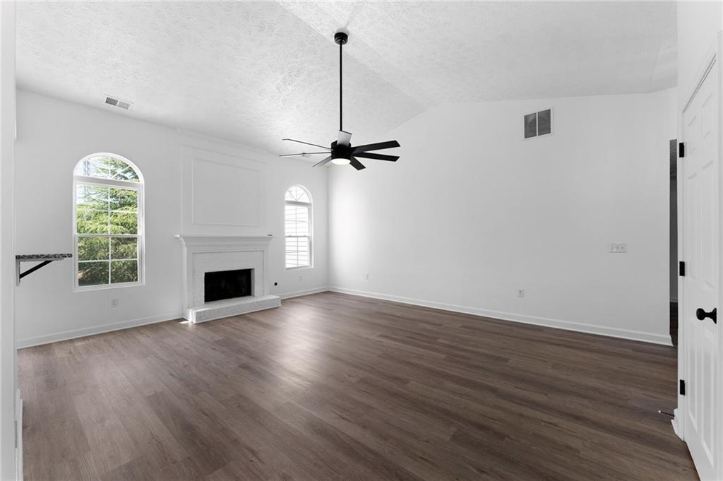 20 Mallet Pointe Street Northeast Cartersville, GA 30121 - Photo 7 of 37 a view of an empty room with wooden floor fireplace and a window