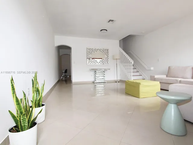 a view of living room with furniture and flowers