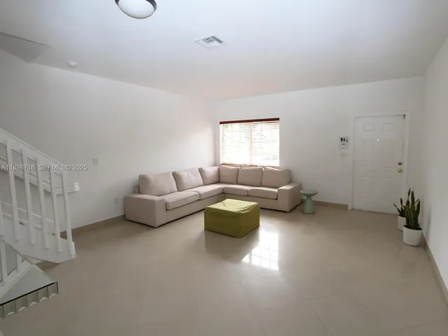 a living room with furniture and a couch