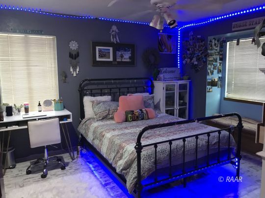 1009 Meadowview Lane Ridgecrest, CA 93555 - Photo 22 of 32 a bedroom with a bed and a table