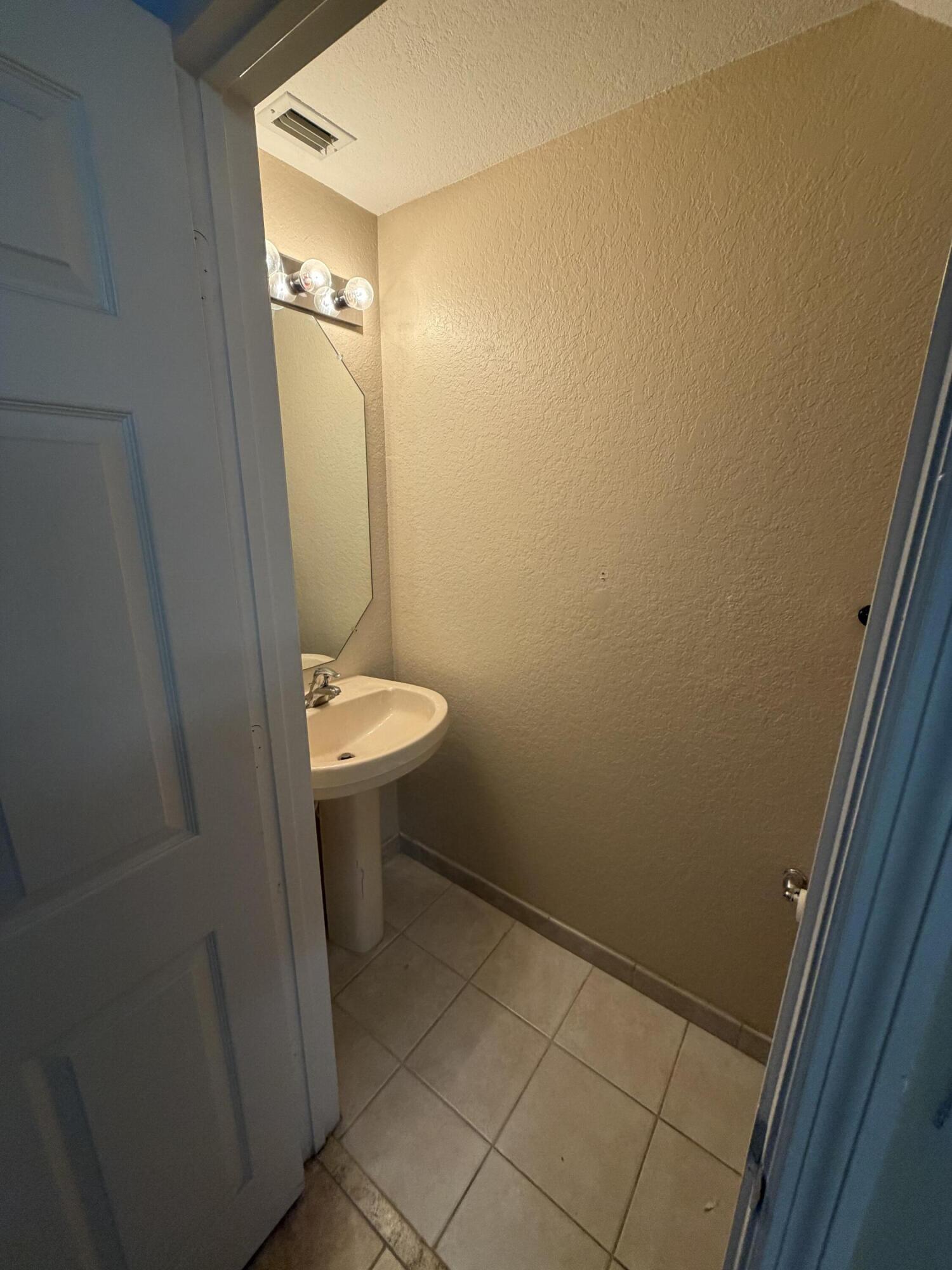 1992 Alamanda Way Riviera Beach, FL 33404 - Photo 12 of 13 a bathroom with a sink and toilet