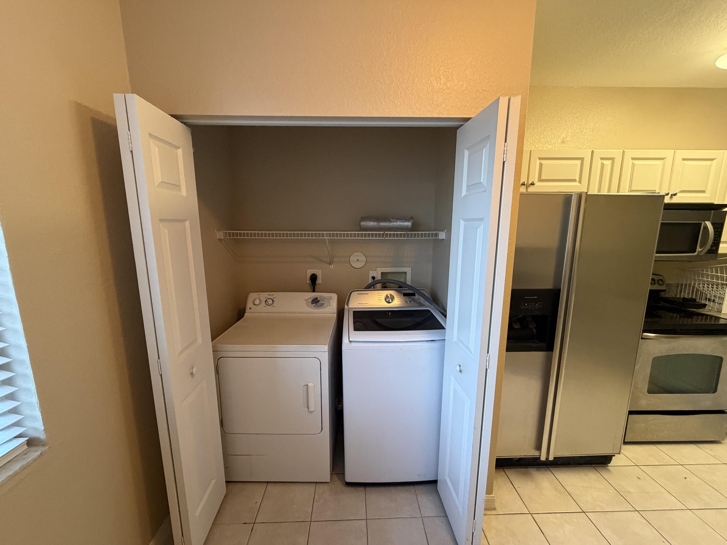 1992 Alamanda Way Riviera Beach, FL 33404 - Photo 9 of 13 a utility room with dryer and washer