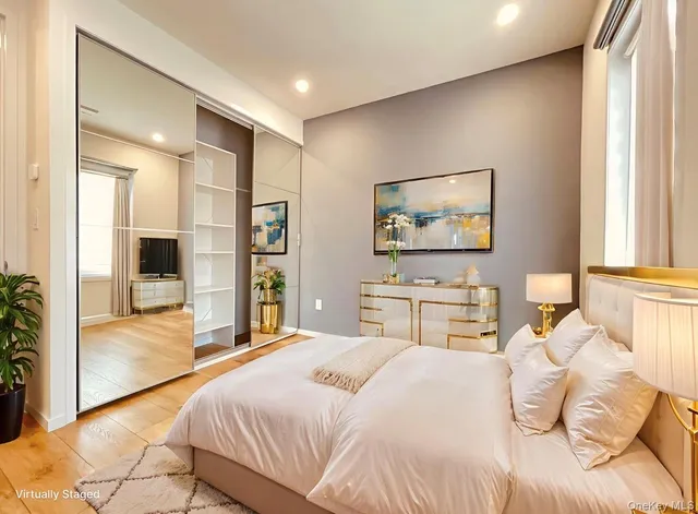 a bedroom with a large bed and a chandelier