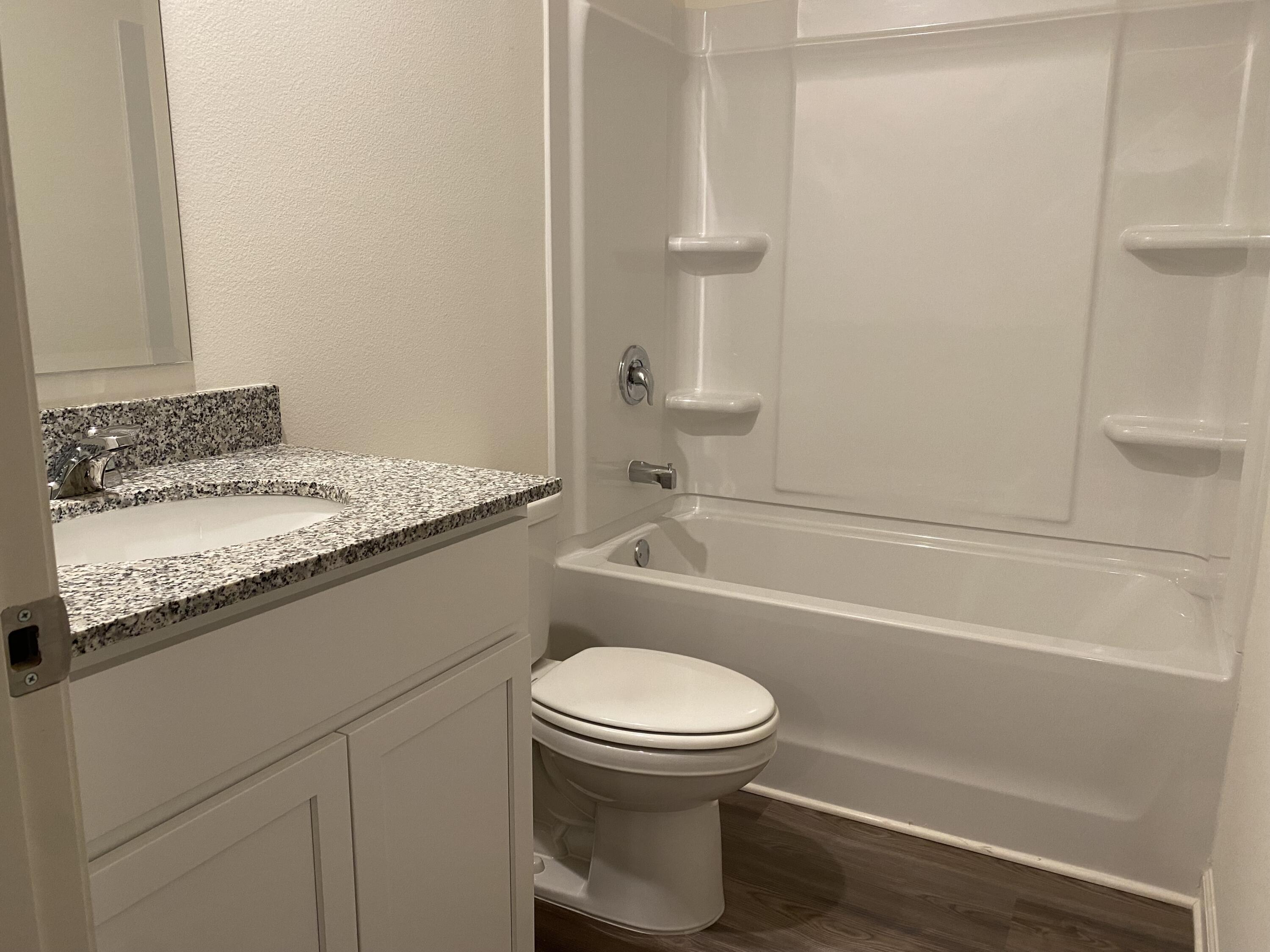 228 Squirrel Road DeFuniak Springs, FL 32433 - Photo 10 of 12 a bathroom with a granite countertop toilet sink and mirror