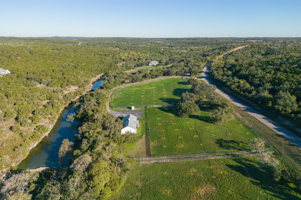 The Gentleman's Ranch everyone dreams to own. Along over 3000 ft of Spring-fed Lone Man Creek.  Stately Home, Barn and irrigated Pastures. Just 5 miles from charming downtown Wimberley.