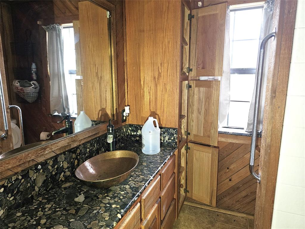 2240 County Road 2162 Barry, TX 75102 - Photo 17 of 33 a bathroom with a sink vanity granite and a mirror