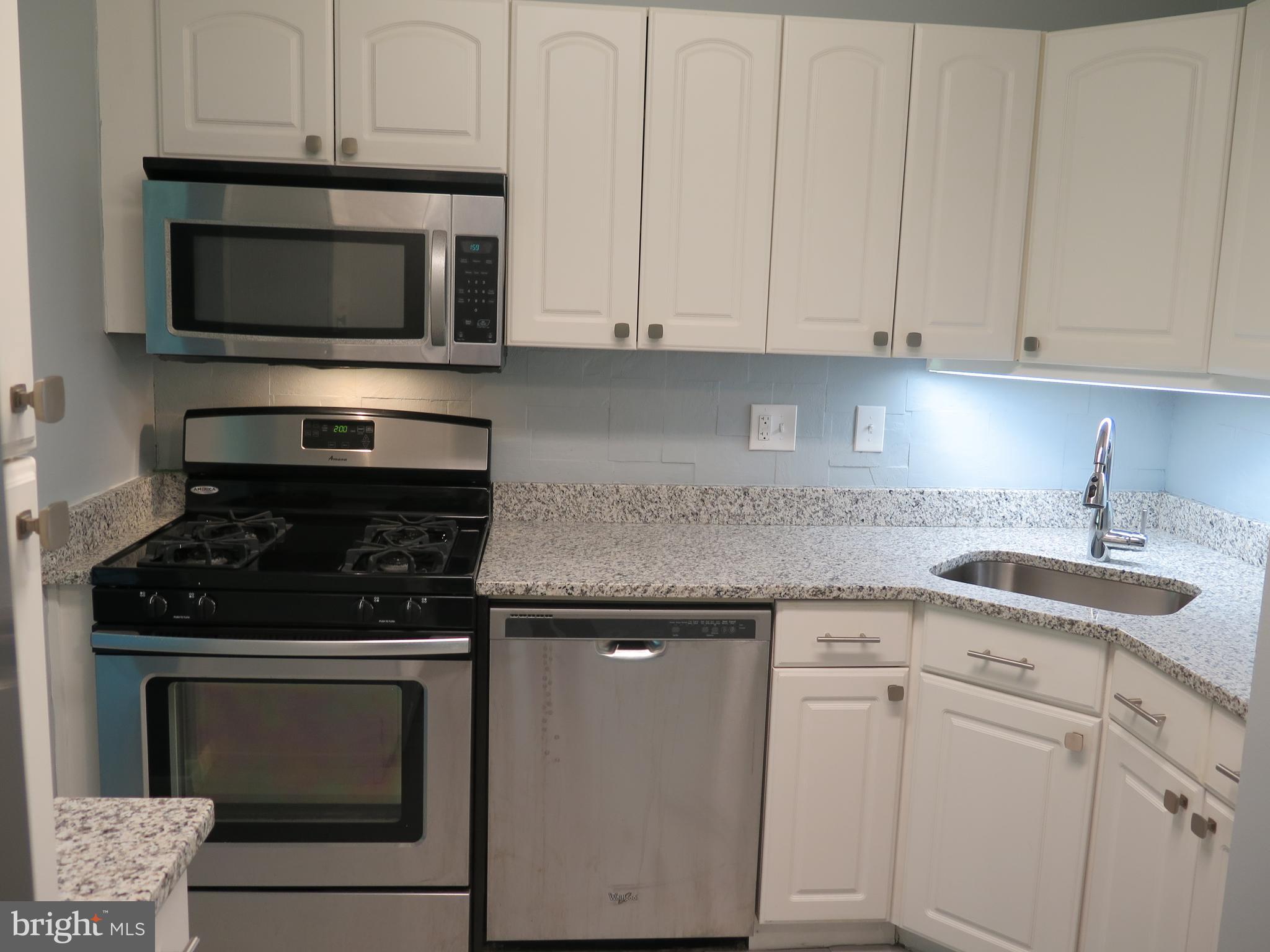 1424 Northgate Square, Unit 21B Reston, VA 20190 - Photo 7 of 28 New granite on white cabinetry - blt in microwave