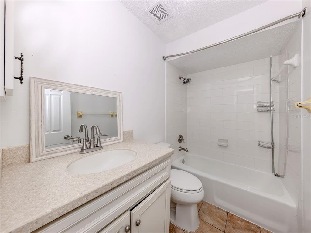 662 Substation Road Venice, FL 34285 - Photo 12 of 26 a bathroom with a granite countertop sink a toilet and shower