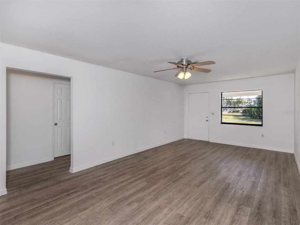 662 Substation Road Venice, FL 34285 - Photo 15 of 26 an empty room with wooden floor and windows