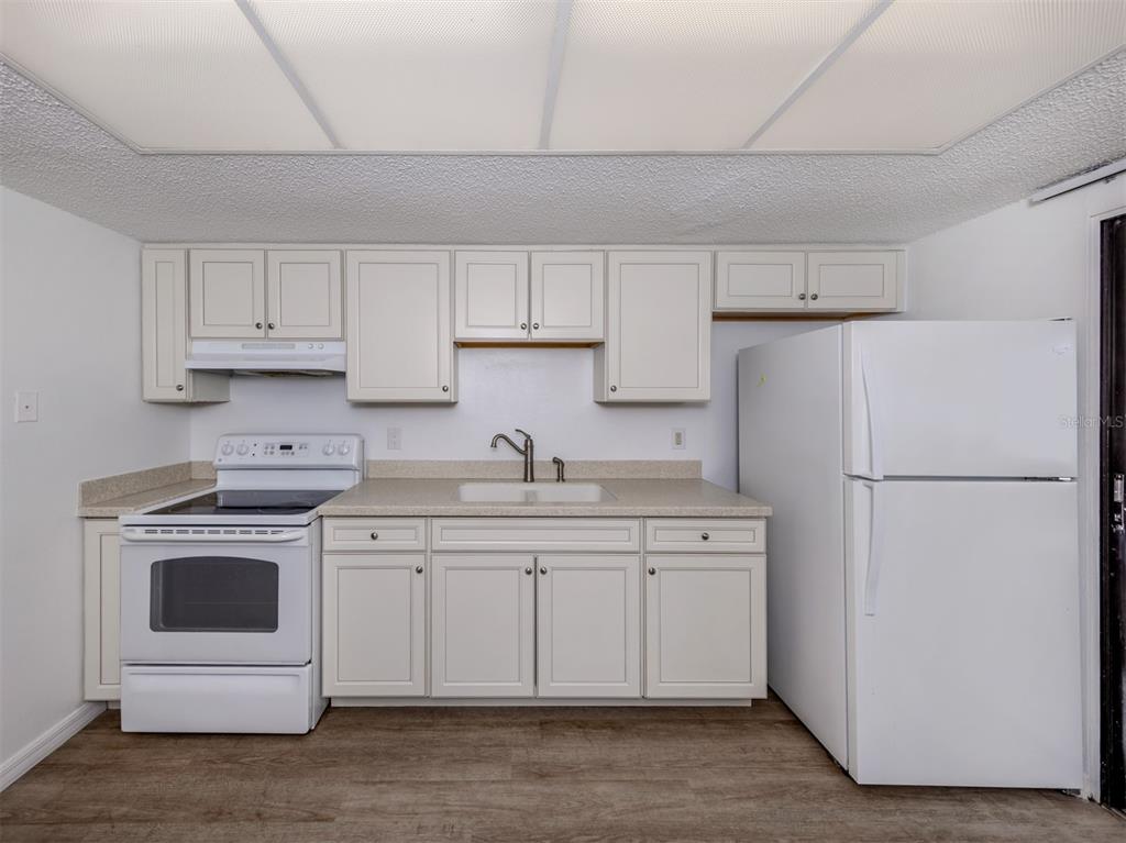 662 Substation Road Venice, FL 34285 - Photo 18 of 26 a kitchen with a white stove top oven and refrigerator