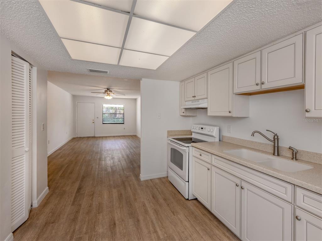 662 Substation Road Venice, FL 34285 - Photo 20 of 26 a kitchen with cabinets wooden floor and a sink