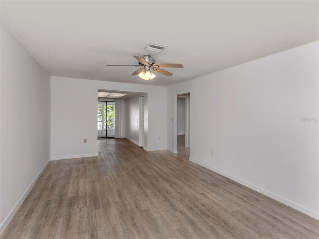 662 Substation Road Venice, FL 34285 - Photo 5 of 26 a view of an empty room with window and wooden floor