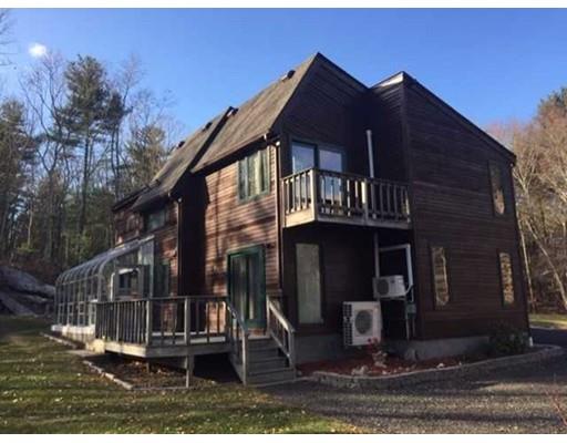 300 Putnam Hill Road Sutton, MA 01590 - Photo 1 of 21 a front view of a house with a yard