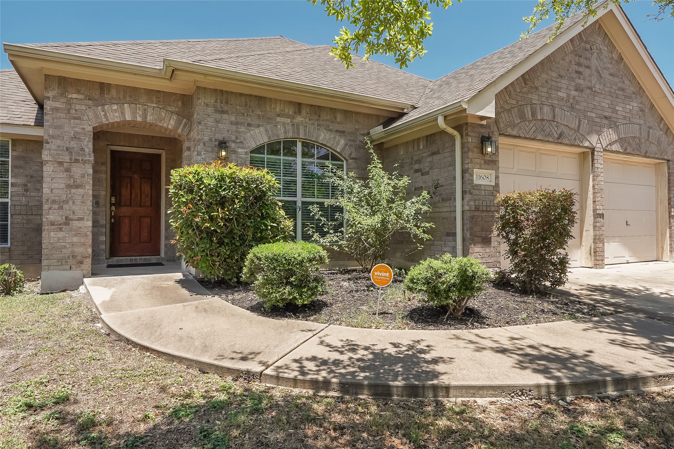 11608 Mill Ridge Trace Manor, TX 78653 - Photo 1 of 1 View of front of house with an attached garage, stone siding, roof with shingles, and driveway