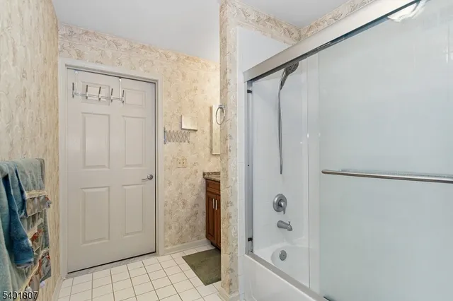a bathroom with a glass shower door