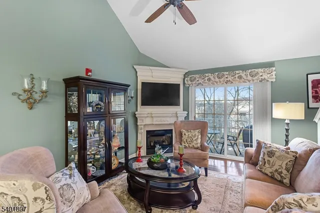 a living room with furniture fireplace and a flat screen tv