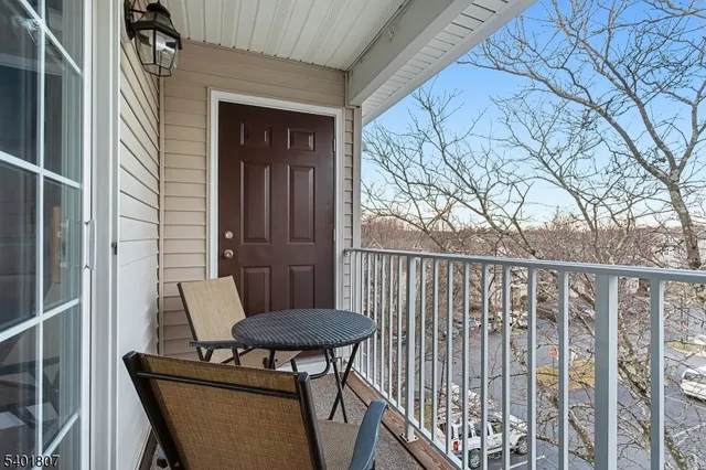 a view of a balcony with table and chairs