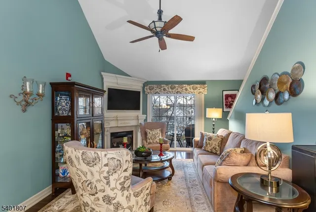 a living room with furniture a fireplace and a flat screen tv