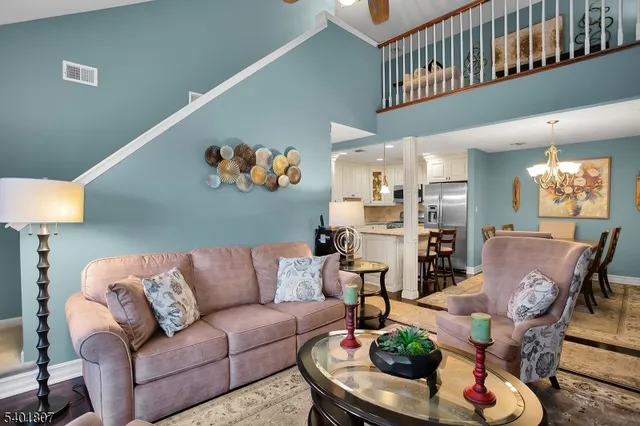 a living room with furniture kitchen and a dining table