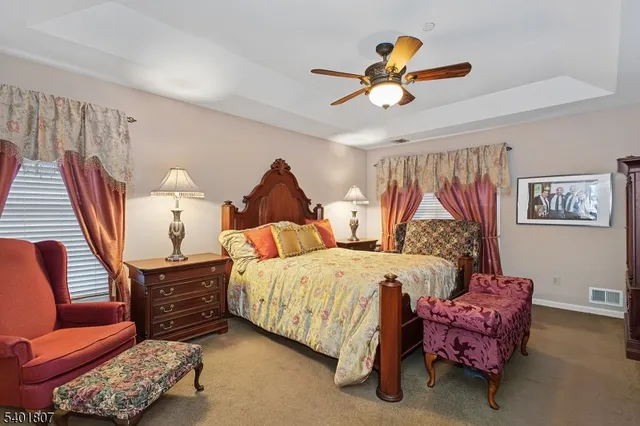 a bedroom with furniture and a chandelier